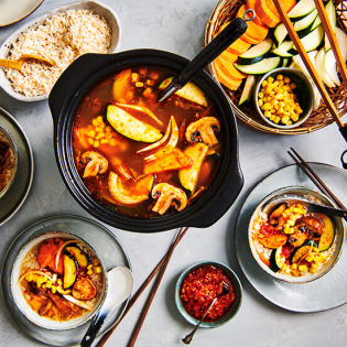 Vegan kimchi hotpot met paddenstoelen en mais